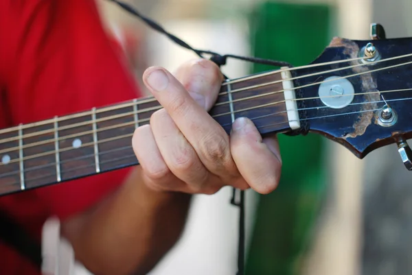 Musician playing on an old acoustic guitar — Stock Photo, Image