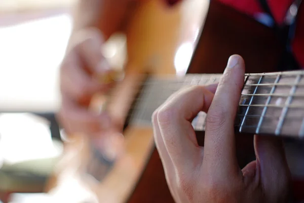 Musician playing on an old acoustic guitar — Stock Photo, Image