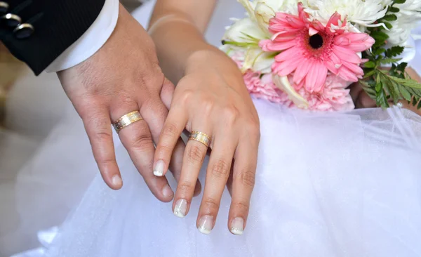 Bruid en bruidegom handen met bruiloft ringen — Stockfoto