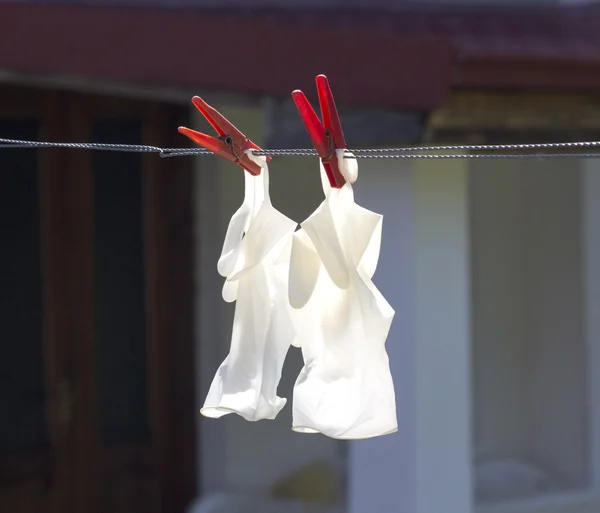 Drying protective gloves on a sun — Stock Photo, Image