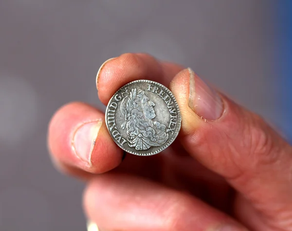 Fingers hold old coin from France — Stock Photo, Image