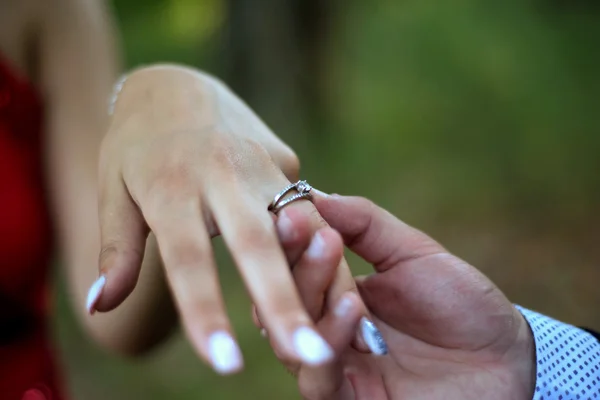 Engagement ring on womans hand held by her friend — Stock Photo, Image