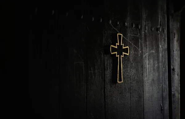 Cruz em uma porta de igreja de madeira — Fotografia de Stock