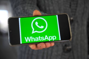 OHRID, NORTH MACEDONIA - JANUARY 17, 2021 : Hand holding smartphone with whatsapp logo on the screen