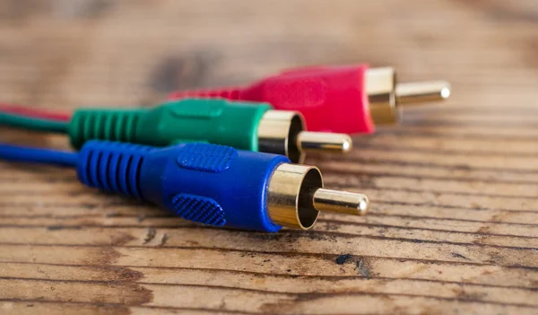 audio-video analog cable on old wood background, red ,green ,blue color concept .