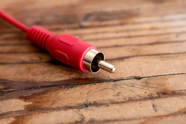 audio-video analog cable on an old wood table background.