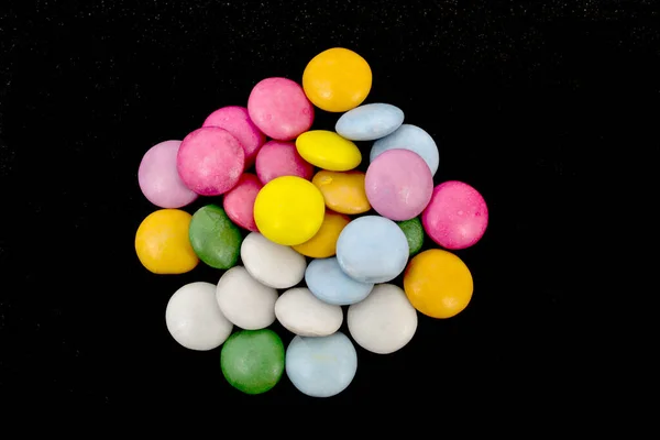 Colorful candy dragees on black background — Stock Photo, Image