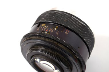 An Old Manual Control Camera Lens Isolated On White clipart