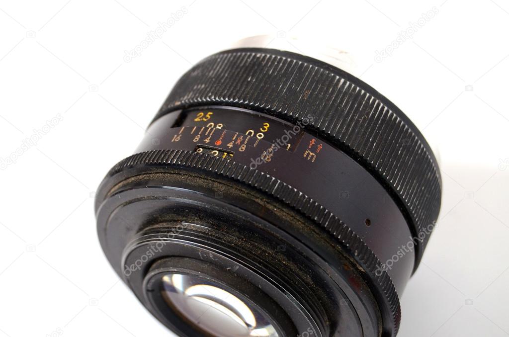 An Old Manual Control Camera Lens Isolated On White