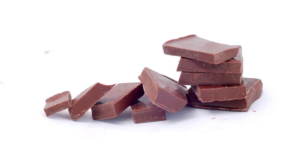 Broken chocolate pieces on white background — Stock Photo, Image