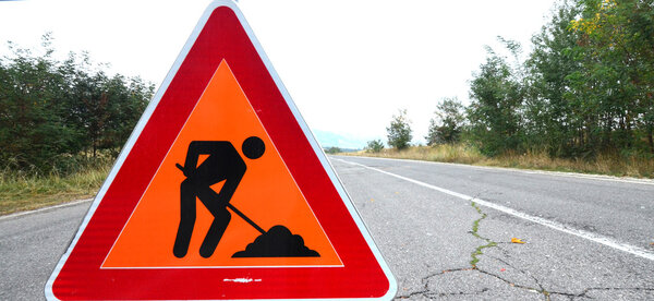 Traffic signs on the road, under reconstruction symbol