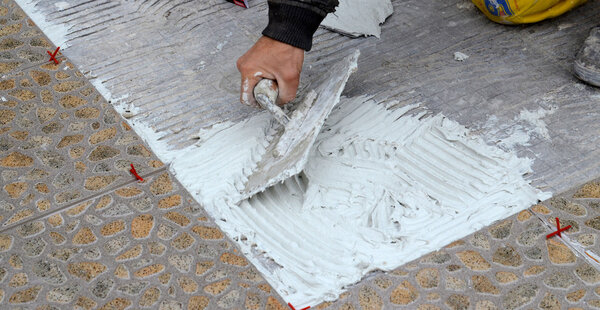Worker tiling the Floor