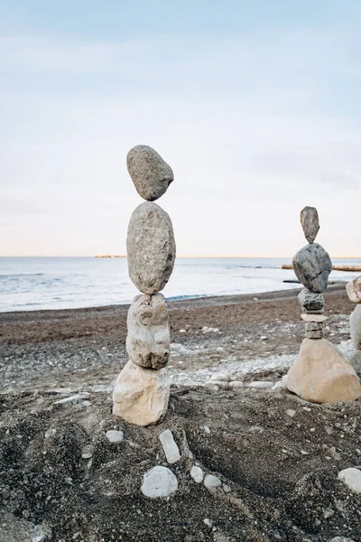 Figures of stones on the beach. Beautiful figures of stones on the background of the sea.