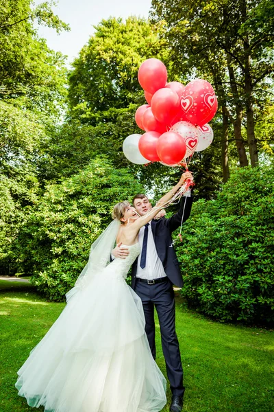 Pareja posando con globos — Foto de Stock