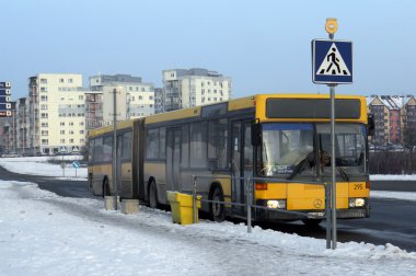 City bus Mercedes at the winter  evening  stop 