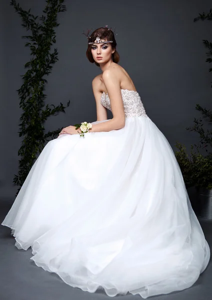 Žena mladá nevěsta ve svatebních šatech na šedém pozadí — Stock fotografie