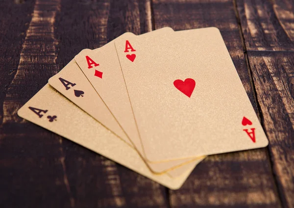 Golden playing cards four aces on wooden board — Stock Photo, Image