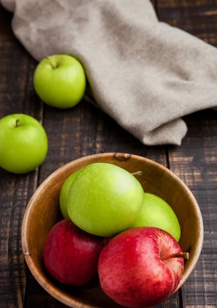 Green and red organic  apples in bowl on wooden board — Stock Photo, Image