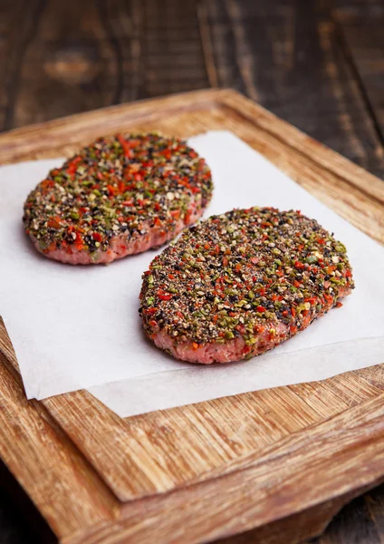 Carne de res carne cruda en tablero de madera de cocina — Foto de Stock