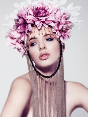 Güzel bir kadınla çiçek taç ve beyaz arka plan üzerinde makyaj