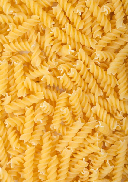 Raw Hemlagad Gul Fusilli Pasta Som Konsistens Bakgrund Ovanifrån — Stockfoto