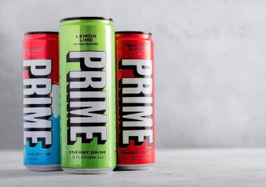 LONDON, İngiltere - 22 Temmuz 2025: Alüminyum teneke kutular dolusu Prime Energy İçeceği ışık masasında çeşitli tatlarla.