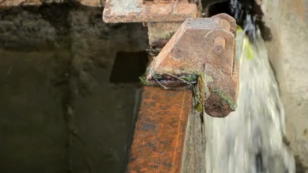 Água corrente na barragem do rio no verão. Gotas de água na estrutura de concreto e metal. Close-up — Vídeo de Stock