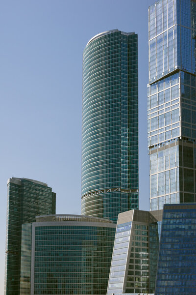 Blue modern office buildings over blue sky