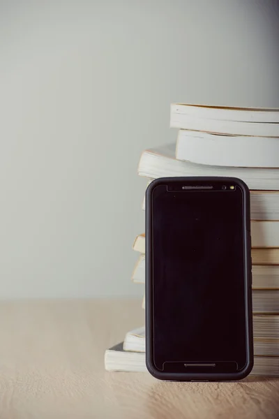 Old vintage books, smartphone — Stock Photo, Image