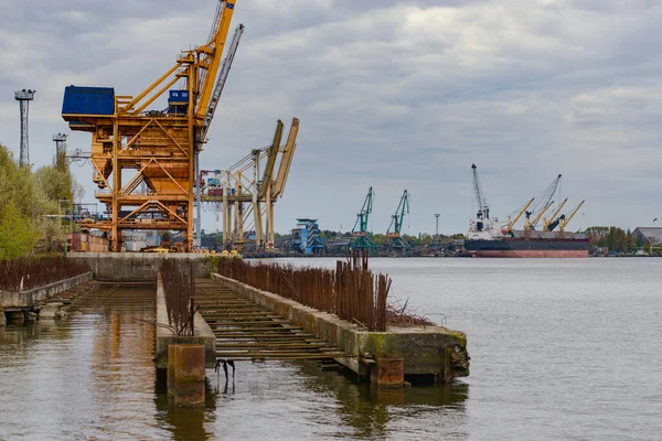 Container ship in export and import business and logistics. Shipping cargo to harbor by crane. Water transport International.