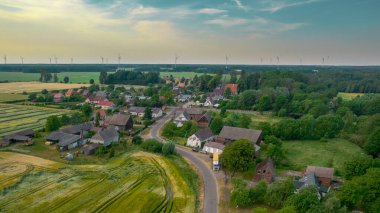 Dağlardaki tipik bir Polonyalı hortum çiftliğinin havadan çekilmiş fotoğrafı. Güneşli bir günde insansız hava aracı ile çekilmiş. Konut arazilerini ve çiftçi tarlalarını gösteriyor.