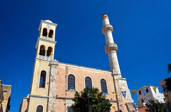 Orthodox church with a bell tower and minaret in the town of Chania — Stock Photo, Image