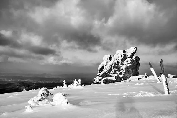 rock and snow-covered tourist trail in the Giant Mountains in Poland, monochrome
