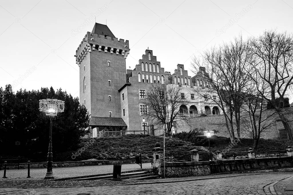 red brick tower reconstructed royal castle  in the evening   in Poznan, monochrome