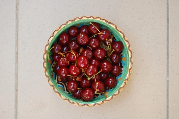 Fresh fruits background with sour cherries in ceramic bowl — Stock Photo, Image