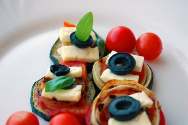 Kızarmış kabak dilimleri domates, Siyah Zeytin, keçi peyniri ve fesleğen ile