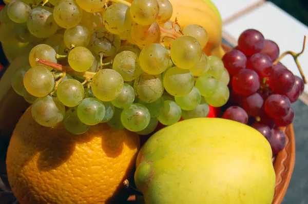 Assorted autumn fruits with grapes and orange — Stock Photo, Image