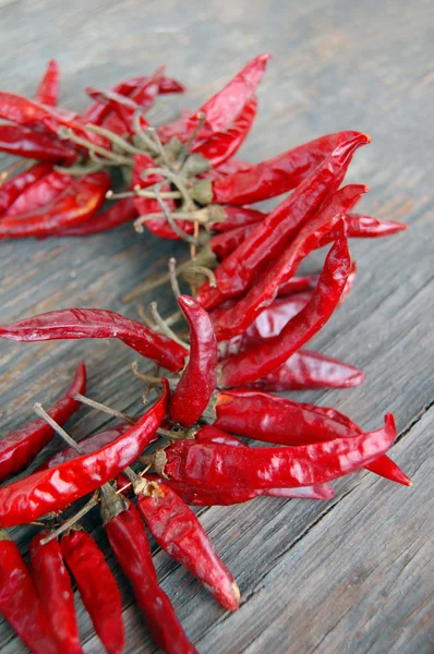 Pimientos rojos picantes sobre mesa de madera — Foto de Stock