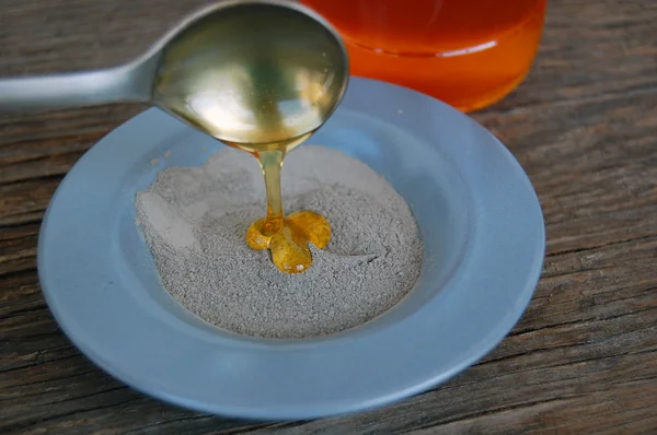Argile cosmétique dans un bol en céramique avec du miel. Spa soin du corps et du visage — Photo