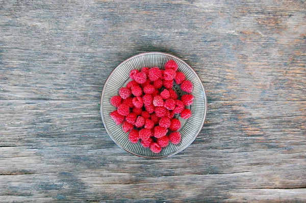 Raspberries on rustic wooden table — Stock Photo, Image