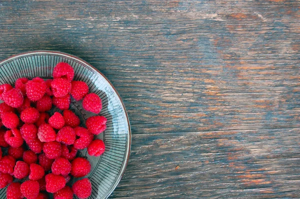 Raspberries on rustic wooden table — Stock Photo, Image