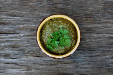 raw vegan mushroom pasty with parsley on wooden table