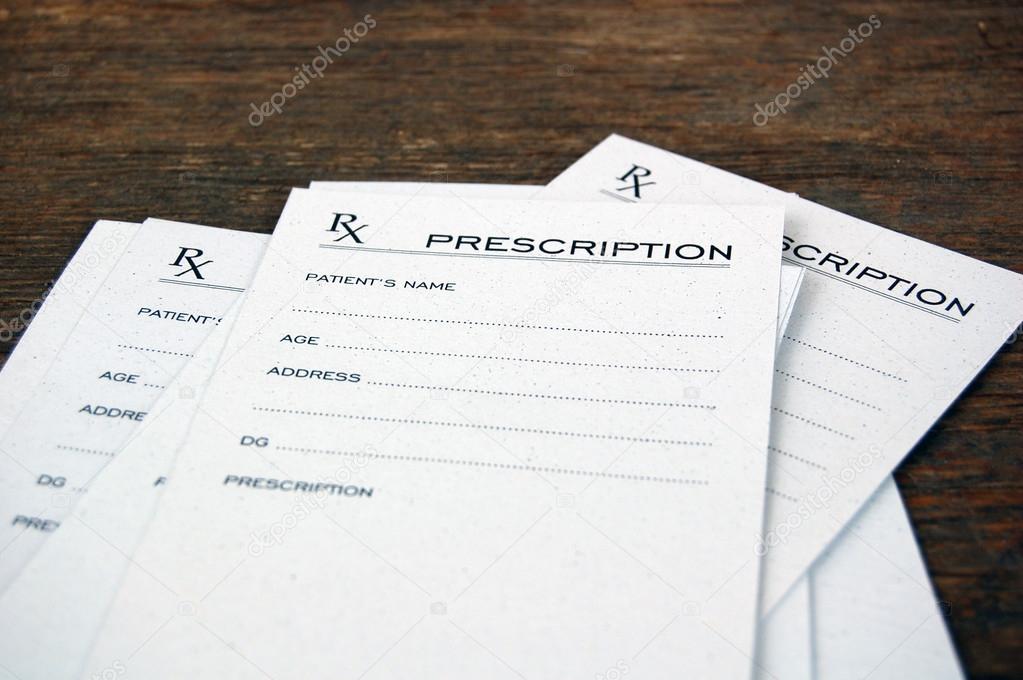 Blank prescriptions over wooden table