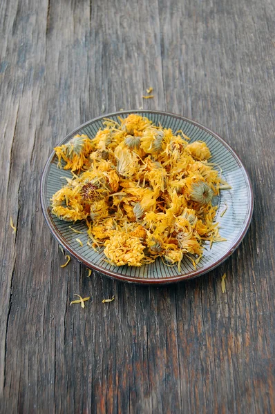 Dried marigold on wooden table — Stock Photo, Image