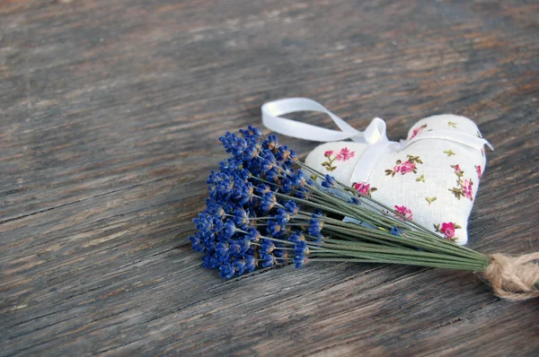 Lavender flowers and lavender bag on table — Stock Photo, Image