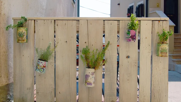 fence decorated with flower pots