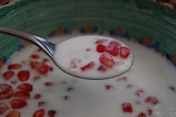 Pomegranate with yogurt in a bowl — Stock Photo, Image