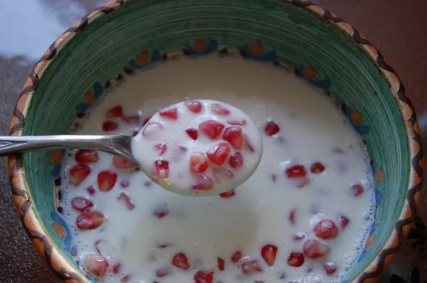 Pomegranate with yogurt in a bowl — Stock Photo, Image