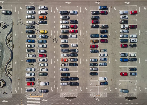 Parking lot from above. Aerial photo of car parking with unrecognizable colorful cars.