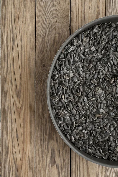 Black sunflower seeds in a frying pan